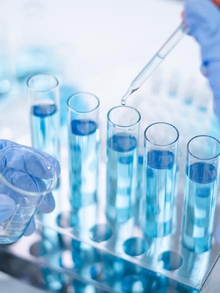 Close-up,Hands,Dropping,Fluid,From,Dropper,Flask,Beaker,Into,Blue Close-up,Hands,Dropping,Fluid,From,Dropper,Flask,Beaker,Into,Blue